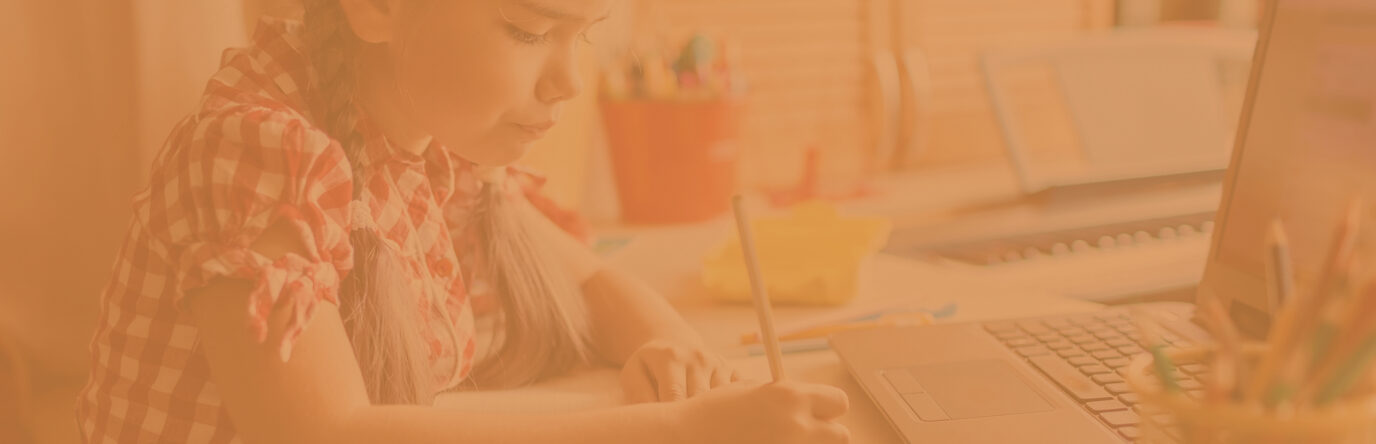 Little girl writing with a pencil in front of laptop 