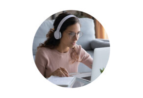 girl on laptop with headphones on 